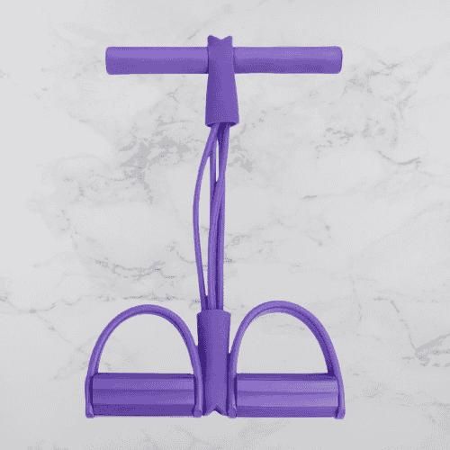 Purple resistance band with handles and foot pedals for home exercise on white marble background