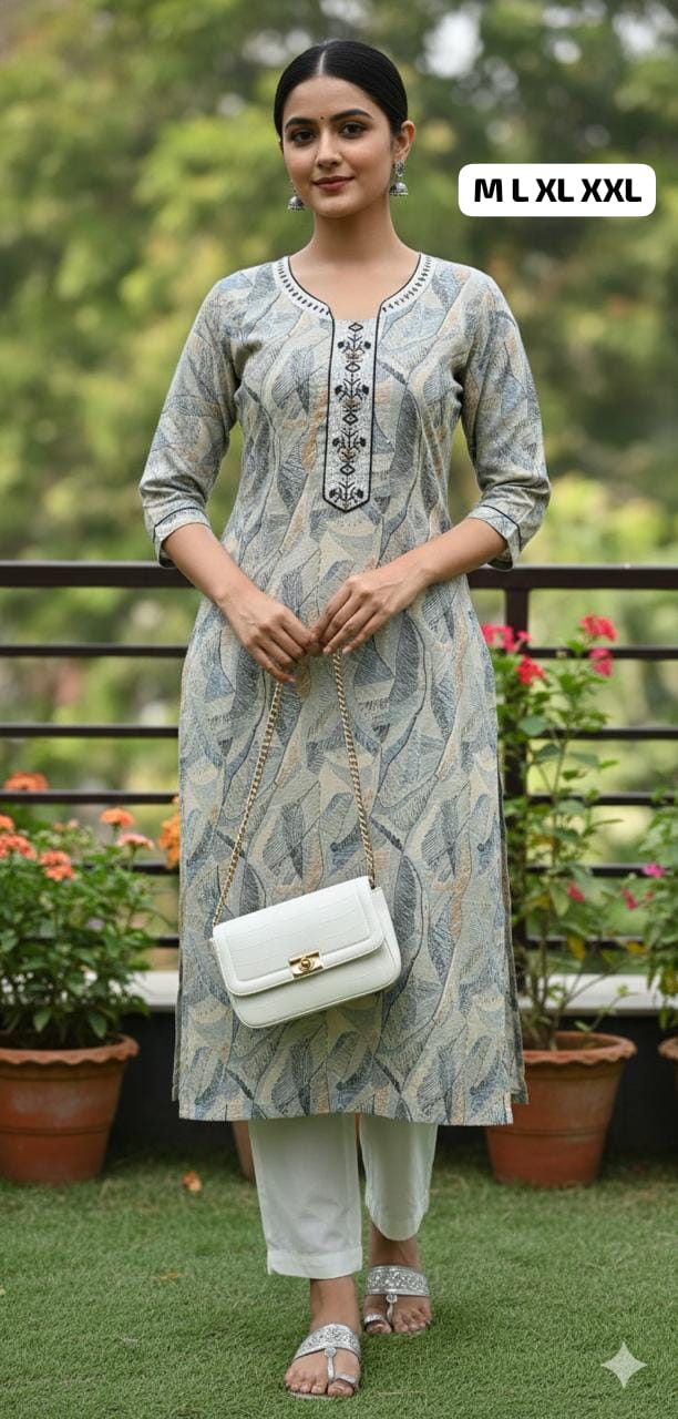 Woman wearing a printed kurti with 3/4 sleeves, white pants, holding a white purse, standing outdoors