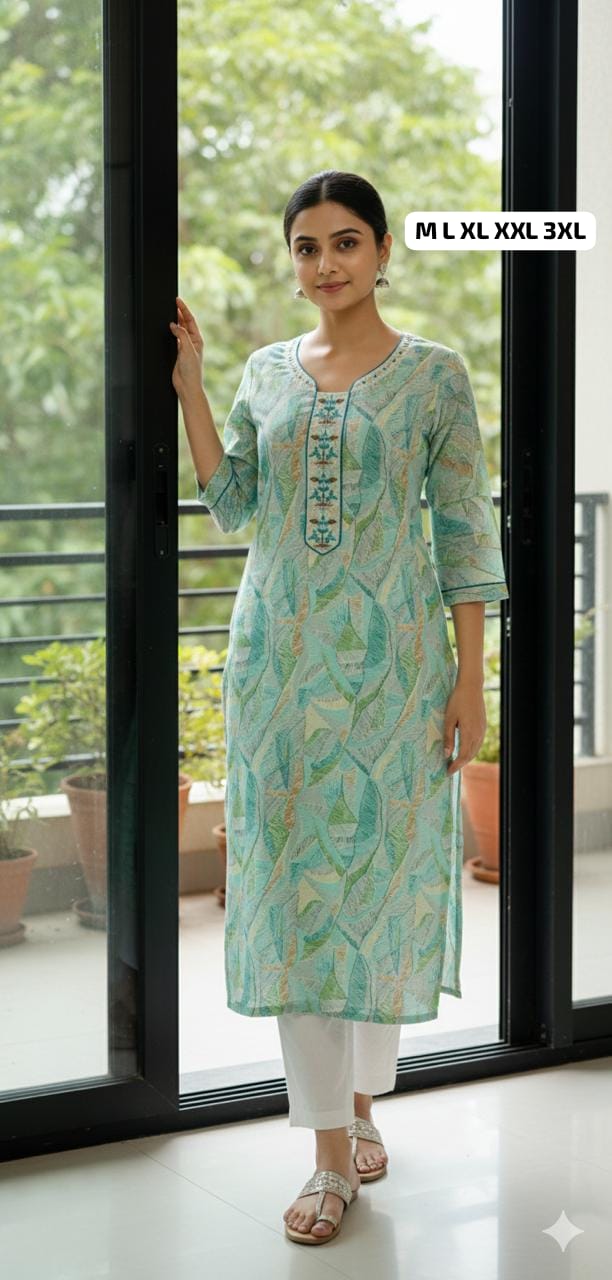 Woman wearing a pastel green patterned kurti with three-quarter sleeves and white pants, standing by a glass door in a bright indoor setting
