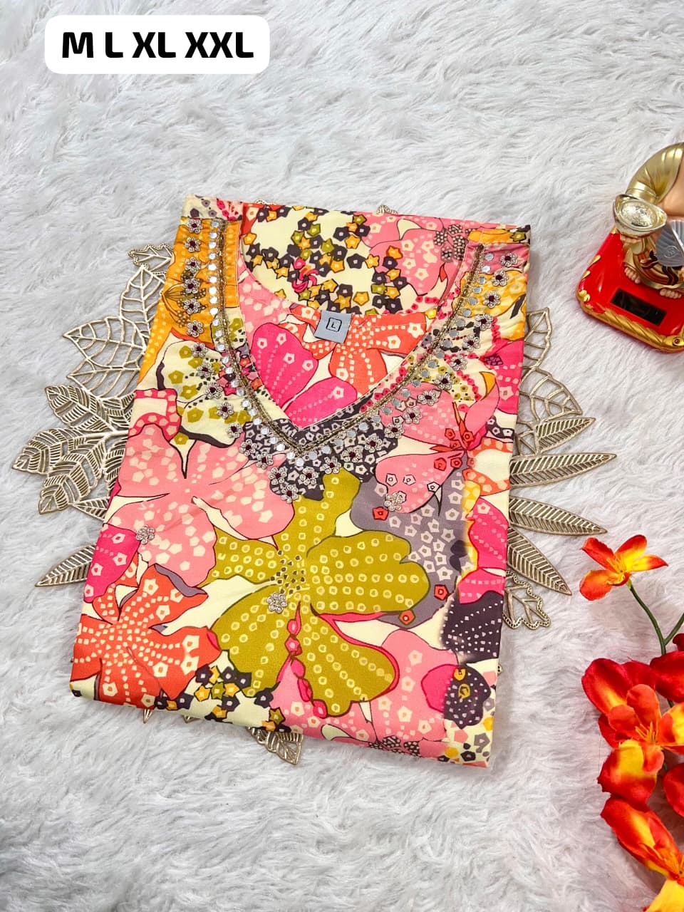 Colorful floral printed women's top with bead embellishments, available in sizes M to XXL on a soft white background